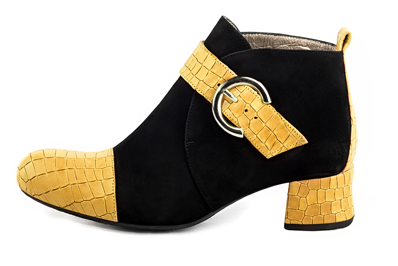 Mustard yellow and matt black women's ankle boots with buckles at the front. Round toe. Low flare heels. Profile view - Florence KOOIJMAN